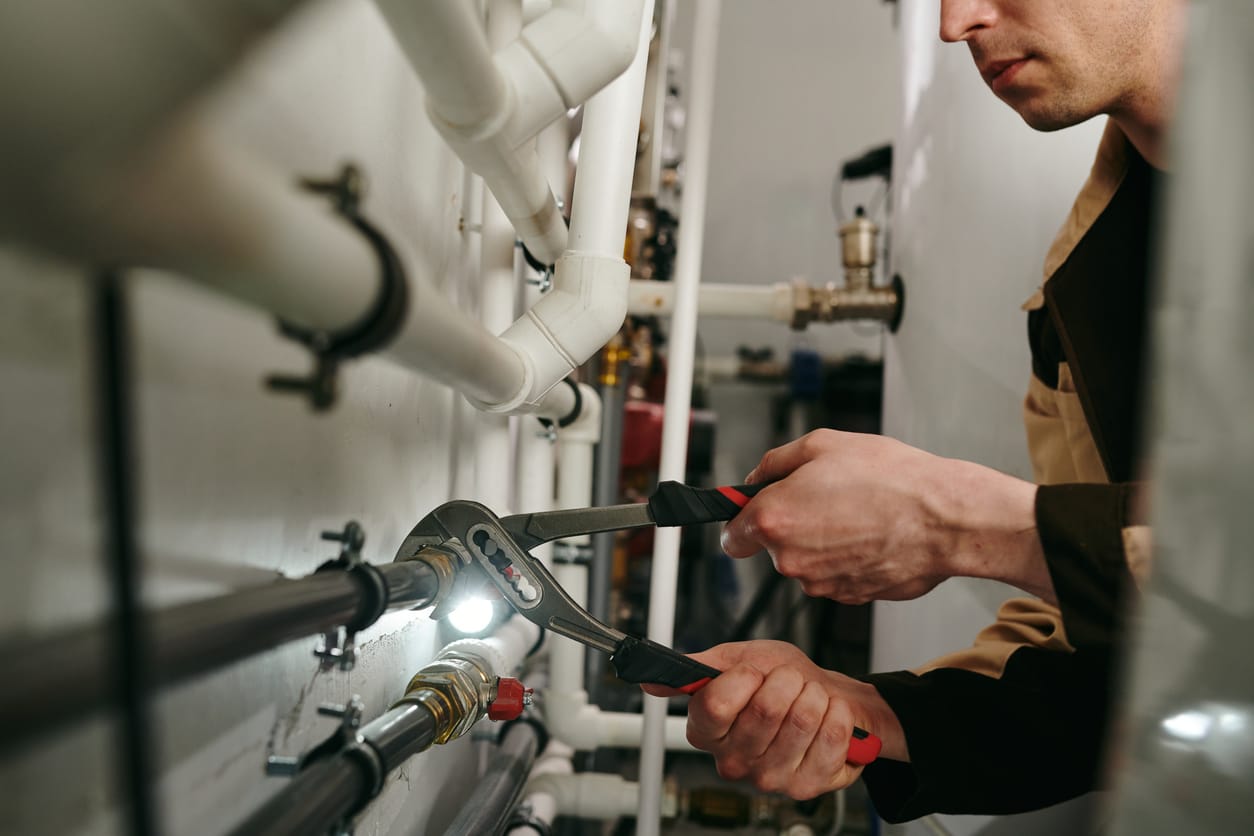 Plumbers maintaining commercial plumbing pipes in Deerfield Beach
