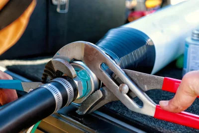 Technician tightening an industrial pipe connection in Deerfield Beach