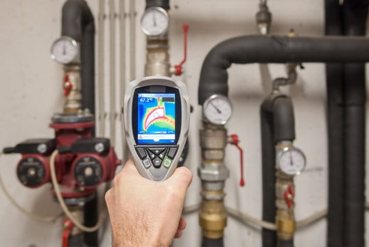 Plumber using a thermal imaging camera to inspect pipes in Deerfield Beach