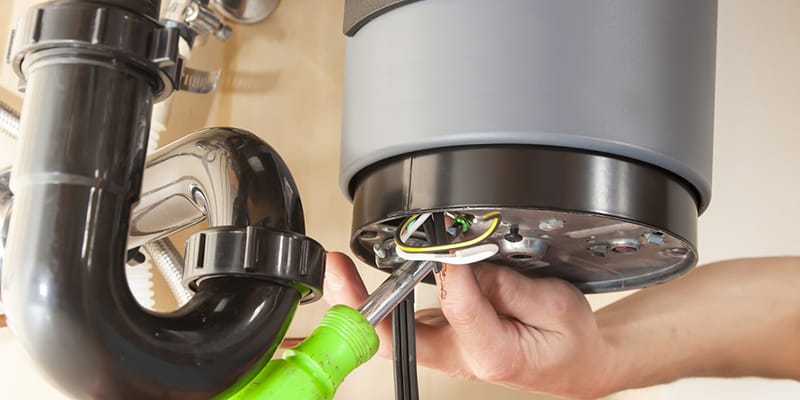 Technician repairing the heating element of a water heater in Deerfield Beach