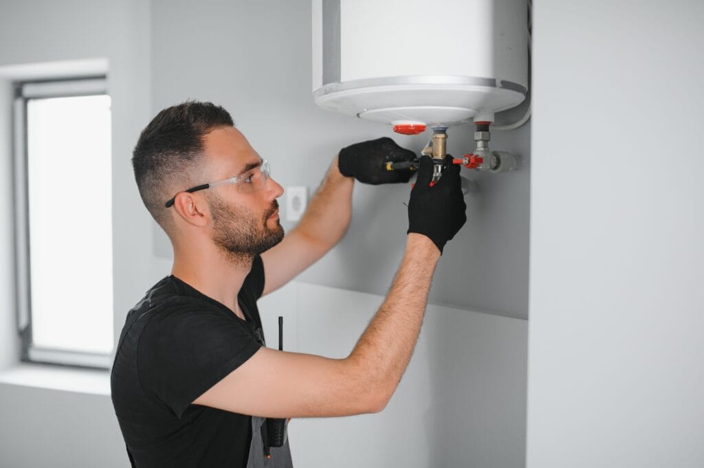 Technician performing water heater maintenance in Deerfield Beach